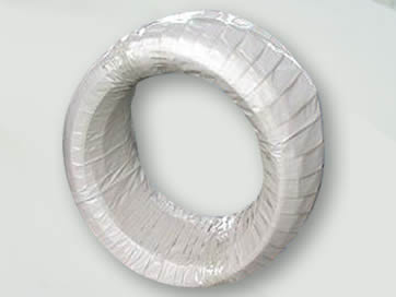 A small coil of PC strand is covered with white PP woven bag.